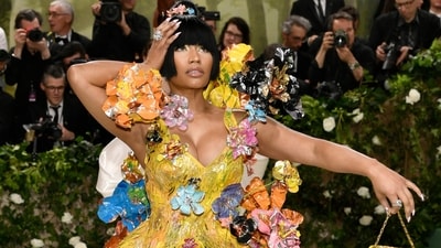 Nicki Minaj impressed with her on-theme attire, dazzling in a floral sculpture gown designed by Marni’s Francesco Risso. Her ensemble, in a captivating yellow hue, showcased a custom hourglass mini dress crafted from hand-painted golden silk duchess material. Adorned with hand-painted 3-D metal flowers in vibrant shades, her outfit exuded charm and elegance. (Evan Agostini/Invision/AP) Nicki Minaj impressed with her on-theme attire, dazzling in a floral sculpture gown designed by Marni’s Francesco Risso. Her ensemble, in a captivating yellow hue, showcased a custom hourglass mini dress crafted from hand-painted golden silk duchess material. Adorned with hand-painted 3-D metal flowers in vibrant shades, her outfit exuded charm and elegance. (Evan Agostini/Invision/AP)