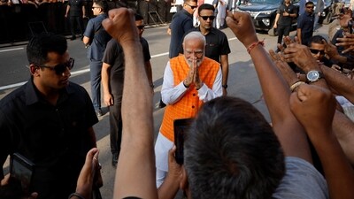 PM Narendra Modi greeted people and&nbsp;signed autographs on his way to the polling booth.&nbsp; (REUTERS)