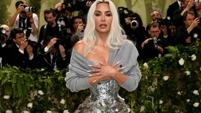 Kim Kardashian wore a sheer Margiela by John Galliano corseted gown with a simple grey sweater for her Met Gala 2024 look. The couture gown was cinched so tight at the waist that it turned her figure into an hourglass version of the X Games. With a stunning nude make-up look and her blonde locks left loose, she looked like a goddess. (Evan Agostini/Invision/AP) Kim Kardashian wore a sheer Margiela by John Galliano corseted gown with a simple grey sweater for her Met Gala 2024 look. The couture gown was cinched so tight at the waist that it turned her figure into an hourglass version of the X Games. With a stunning nude make-up look and her blonde locks left loose, she looked like a goddess. (Evan Agostini/Invision/AP)