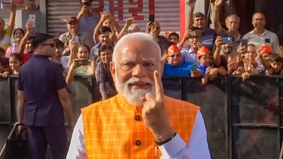 The PM, who arrived in Ahmedabad on Monday night, cast his vote in the polling booth after getting his finger inked. (PTI) The PM, who arrived in Ahmedabad on Monday night, cast his vote in the polling booth after getting his finger inked. (PTI)