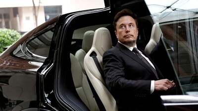 Tesla layoffs: Tesla Chief Executive Officer Elon Musk gets in a Tesla car as he leaves a hotel in Beijing, China. (Reuters)