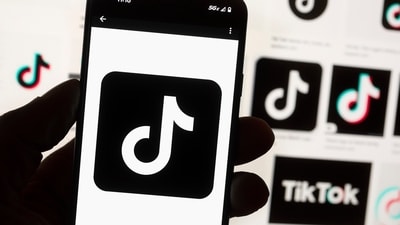 FILE - The TikTok logo is displayed on a mobile phone in front of a computer screen, Oct. 14, 2022, in Boston. On Tuesday, May 7, 2024, TikTok and its Chinese parent company ByteDance filed suit against the U.S. federal government to challenge a law that would force the sale of ByteDance's stake or face a ban, saying that the law is unconstitutional. (AP Photo/Michael Dwyer, File) (AP) FILE - The TikTok logo is displayed on a mobile phone in front of a computer screen, Oct. 14, 2022, in Boston. On Tuesday, May 7, 2024, TikTok and its Chinese parent company ByteDance filed suit against the U.S. federal government to challenge a law that would force the sale of ByteDance's stake or face a ban, saying that the law is unconstitutional. (AP Photo/Michael Dwyer, File) (AP)