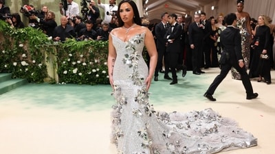 Demi Lovato stunned at the Met Gala in a strapless silver gown adorned with floral embellishments, designed by Prabal Gurung. Completing her ensemble, she wore a statement-making diamond necklace that shimmered brighter than neon lights, adding an extra touch of glamour. (REUTERS)