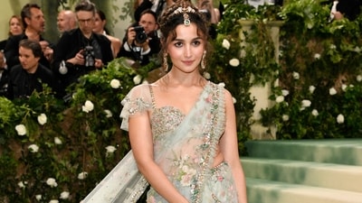 Alia Bhatt made a grand entrance in a breathtaking floral saree, along with a long train, marking her second appearance at the prestigious event. (AP) Alia Bhatt made a grand entrance in a breathtaking floral saree, along with a long train, marking her second appearance at the prestigious event. (AP)