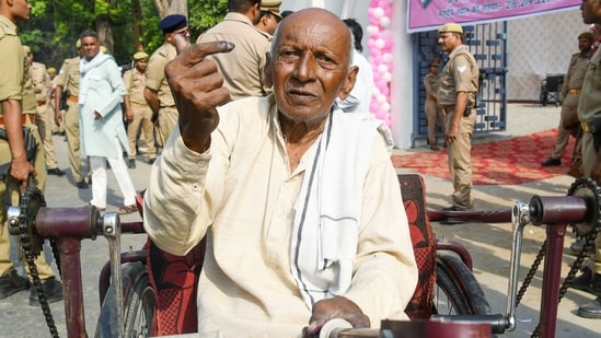 A senior voter shows his ink-marked finger after casting his vote in Etawah, Uttar Pradesh.(ANI)