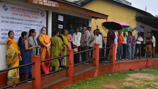 Voters wait to cast their vote for the third phase of Lok Sabha elections, in Guwahati. (PTI)