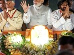 Prime Minister Narendra Modi along with TDP chief N Chandrababu Naidu and Jana Sena Party chief Pawan Kalyan holds a roadshow in Vijayawada on Wednesday.(ANI)