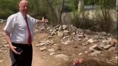 Svane is seen standing in the middle of the lane and pointing to the trash and construction debris scattered on the sides of the road. (X) Svane is seen standing in the middle of the lane and pointing to the trash and construction debris scattered on the sides of the road. (X)