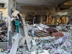 A Palestinian man inspects a house hit in an Israeli strike, amid the ongoing conflict between Israel and the Palestinian Islamist group Hamas, in Rafah
