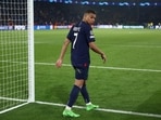 Paris Saint-Germain's French forward #07 Kylian Mbappe looks back dejected as he walks off the field 