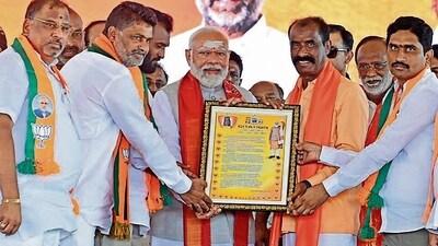 PM Narendra Modi being felicitated by BJP members during an election rally in Karimnagar district of Telangana on Wednesday. (ANI) (HT_PRINT)
