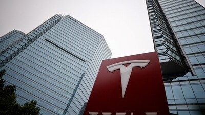 Tesla layoffs: A Tesla logo is seen outside a showroom of the carmaker in Beijing, China. (Reuters)