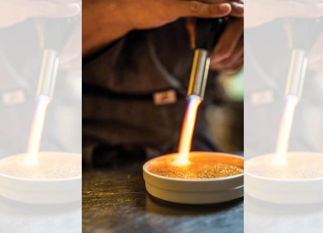 In the final stages of preparing a crème brûlée, which distinguishes it from a crème caramel, a blowtorch is used to caramelise the sugar on top. (ADOBE STOCK) In the final stages of preparing a crème brûlée, which distinguishes it from a crème caramel, a blowtorch is used to caramelise the sugar on top. (ADOBE STOCK)