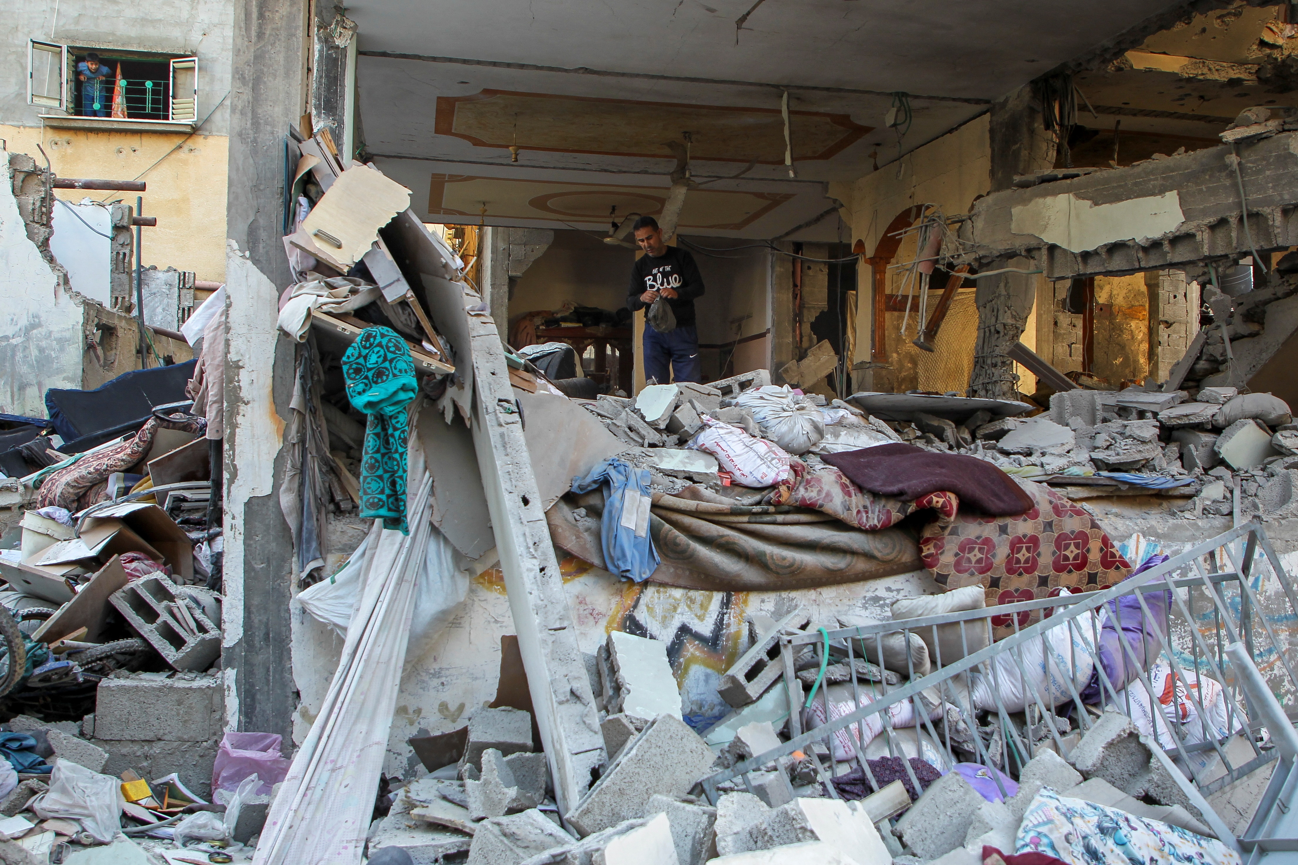 A Palestinian man inspects a house hit in an Israeli strike, amid the ongoing conflict between Israel and the Palestinian Islamist group Hamas, in Rafah (REUTERS)