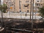 Traces of a fire are visible as an ultra-Orthodox Israel man walks past the headquarters of the United Nations Relief and Works Agency for Palestine Refugees (UNRWA). (AFP) Traces of a fire are visible as an ultra-Orthodox Israel man walks past the headquarters of the United Nations Relief and Works Agency for Palestine Refugees (UNRWA). (AFP)