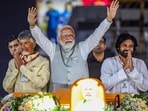 Vijayawada: Prime Minister Narendra Modi with JanaSena party President and actor Pawan Kalyan and Telugu Desam Party (TDP) President N Chandrababu Naidu during an election roadshow for the Lok Sabha elections, in Vijayawada.