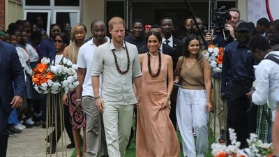 Britain's Prince Harry, Duke of Sussex and his wife Meghan, Duchess of Sussex, walk out after meeting the students at the Lightway Academy in Abuja, Nigeria, May 10, 2024. ( REUTERS/Akintunde Akinleye)