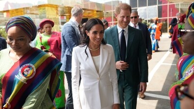 Prince Harry and Meghan Markle were received at the Abuja school by a dancing troupe and a crowd of excited students and teachers. (AP) Prince Harry and Meghan Markle were received at the Abuja school by a dancing troupe and a crowd of excited students and teachers. (AP)