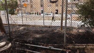 Traces of a fire are visible as an ultra-Orthodox Israel man walks past the headquarters of the United Nations Relief and Works Agency for Palestine Refugees (UNRWA). (AFP) Traces of a fire are visible as an ultra-Orthodox Israel man walks past the headquarters of the United Nations Relief and Works Agency for Palestine Refugees (UNRWA). (AFP)