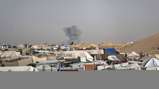 Smoke from an Israeli military strike in the distance seen from al-Mawasi on the outskirts of Rafah, Gaza, on Thursday, May 9, 2024. Israeli Prime Minister�Benjamin Netanyahu said Israel must go into Rafah to finish off the remaining battalions of Hamas, the US-designated terrorist group that killed 1,200 Israelis and kidnapped about 250 last Oct. 7. Photographer: Ahmad Salem/Bloomberg (Bloomberg)