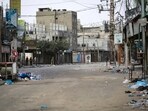 People walk along a nearly deserted street in Rafah in the southern Gaza Strip. (AFP)