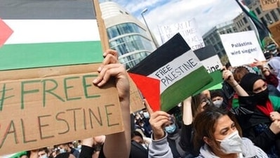 With flags of Palestine in hand, hundreds of people demonstrate at the Hauptwache in Frankfurt/Main, Germany, Saturday, May 15, 2021. (Boris Roessler/dpa via AP) With flags of Palestine in hand, hundreds of people demonstrate at the Hauptwache in Frankfurt/Main, Germany, Saturday, May 15, 2021. (Boris Roessler/dpa via AP)