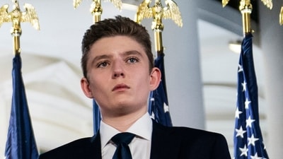 In the video, Barron Trump can be seen greeting guests and speaking to them. "Impressed with this?" Donald Trump's son appears to question the attendee, alluding to the posh celebration taking place in a Mar-a-Lago ballroom. (AP)
