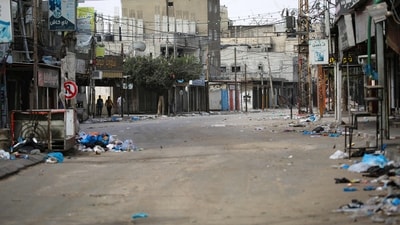 People walk along a nearly deserted street in Rafah in the southern Gaza Strip. (AFP) People walk along a nearly deserted street in Rafah in the southern Gaza Strip. (AFP)