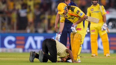 A pitch invader touches MS Dhoni's feet during an Indian Premier League (IPL) 2024 T20 cricket match between Gujarat Titans and Chennai Super Kings (PTI) A pitch invader touches MS Dhoni's feet during an Indian Premier League (IPL) 2024 T20 cricket match between Gujarat Titans and Chennai Super Kings (PTI)