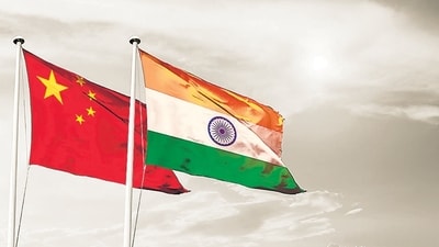China India national flag cloth fabric waving on the sky with beautiful sun light - Image (Shutterstock) China India national flag cloth fabric waving on the sky with beautiful sun light - Image (Shutterstock)