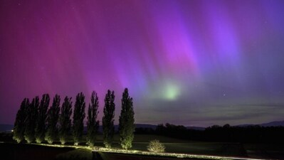 Daillens, Switzerland: Northern Lights flare in the night sky as a car passes by, spotlighting poplars in this long exposure shot. ((Laurent Gillieron/Keystone via AP)) Daillens, Switzerland: Northern Lights flare in the night sky as a car passes by, spotlighting poplars in this long exposure shot. ((Laurent Gillieron/Keystone via AP))