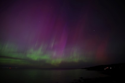 The aurora borealis, northern lights, light up the sky over the ocean off Gloucester, Massachusetts, U.S., May 10, 2024.  REUTERS/Brian Snyder (REUTERS)