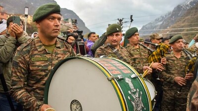Indian Army personnel perform at the Shri Badrinath temple after its portals were opened on Sunday. (PTI) Indian Army personnel perform at the Shri Badrinath temple after its portals were opened on Sunday. (PTI)