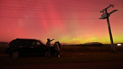 People look at the Aurora Australis in Rolleston outskirts of Christchurch. (AFP) People look at the Aurora Australis in Rolleston outskirts of Christchurch. (AFP)