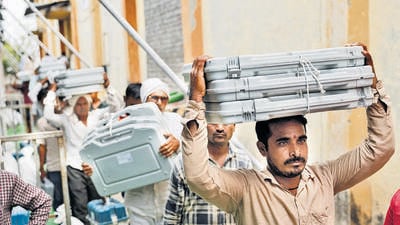 Volunteers carry Voter Verifiable Paper Audit Trail (VVPAT) and Electronic Voting Machines (EVM) inside a distirbution centre in Beed (REUTERS) Volunteers carry Voter Verifiable Paper Audit Trail (VVPAT) and Electronic Voting Machines (EVM) inside a distirbution centre in Beed (REUTERS)