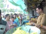 A long queue of voters was seen getting breakfast at the shops at 56 Dukan Market in the city. (Screengrab/ANI)