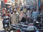 In this picture taken on March 14, 2024, people make their way through a busy market area near the Jama Masjid (mosque) at Rampur in India's Uttar Pradesh state. More than half the voters in India's city of Rampur are Muslim, but its member of parliament is a staunch supporter of Prime Minister Narendra Modi's muscular Hindu-first agenda. While India's 220 million Muslims make up 14 percent of the 1.4 billion population, Muslim representatives in parliament have almost halved to under five percent since the 1970s. (Photo by AFP) / To go with India-vote-religion-Islam-rights, FOCUS by Parvaiz BUKHARI