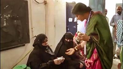 BJP candidate Madhavi Latha checks identity of voters at a polling station during the fourth phase of Lok Sabha elections in Hyderabad on Monday. (PTI)
