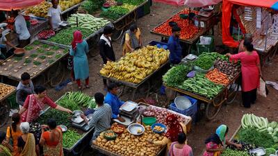 FILE PHOTO: Customers buy fruits and vegetables at an open air evening market in Ahmedabad (REUTERS) FILE PHOTO: Customers buy fruits and vegetables at an open air evening market in Ahmedabad (REUTERS)