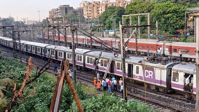 Mumbai weather: Mumbai's local train services on the Central Railway were affected after an overhead equipment pole between Thane and Mulund stations got bent due to strong winds. (HT photo/ Praful Gangurde)