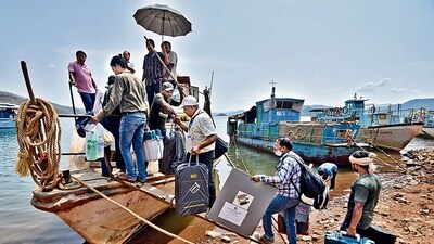 Polling officials board a boat with election material in Chitrakonda, Odisha, on Sunday. (REUTERS) Polling officials board a boat with election material in Chitrakonda, Odisha, on Sunday. (REUTERS)