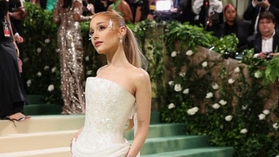 Pop sensation Ariana Grande graced the Met Gala 2024 red carpet, captivating all with her celestial-inspired ensemble. Designed by Loewe's creative director, Jonathan Anderson, her ethereal outfit boasts a sculpted bodice crafted entirely from mother of pearl, paired with a flowing white skirt adorned with floral eye decorations. (REUTERS)