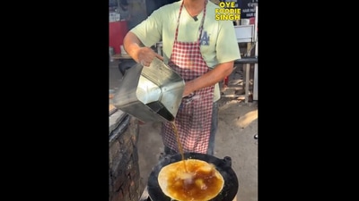 The image, taken from a viral video on X, shows a man cooking a paratha in "diesel". The image, taken from a viral video on X, shows a man cooking a paratha in "diesel".