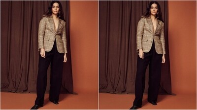 Sonam's outfits features a single-breated blazer that comes in a luxurious linen fabric and boasts plaid check pattern, notched lapels, front button fastening, long sleeves, buttoned cuffs and two side flap pockets. She paired it up with a black relaxed fit pleated-front wool pants.&nbsp; (Instagram/@sonamkapoor)