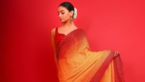 Alia Bhatt looks ethereal in a yellow and red dual ombre-toned bandhani saree. (Instagram) Alia Bhatt looks ethereal in a yellow and red dual ombre-toned bandhani saree. (Instagram)