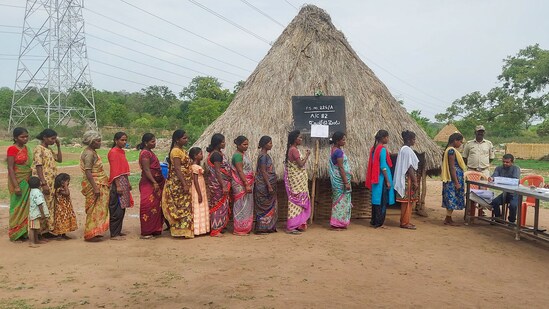 People wait in a queue to cast their vote at Auxiliary Polling Station in Nagarkurnool, Telangana.(PTI)