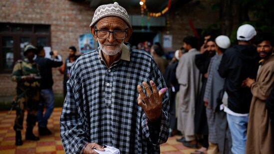 A senior voter shows his ink-marked finger after casting his vote in Pulwama district, Jammu and Kashmir.(Reuters)