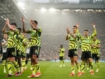Arsenal's players celebrate after winning the English Premier League match against Manchester United.