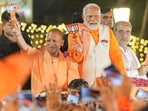 Prime Minister Narendra Modi with Uttar Pradesh chief minister Yogi Adityanath during a roadshow for the Lok Sabha elections in Varanasi on May 13. Prime Minister Narendra Modi with Uttar Pradesh chief minister Yogi Adityanath during a roadshow for the Lok Sabha elections in Varanasi on May 13.
