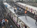 Suburban train services on Central Railway (CR) were affected after an overhead equipment (OHE) mast supplying power to the trains collapsed between Thane and Mulund stations at around 4 pm. Around the same time, a banner too fell on the OHE cables between these two stations. (Praful Gangurde / HT Photo)